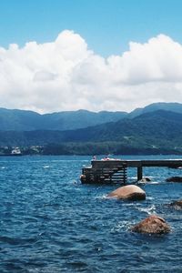 Jetty in sea against sky