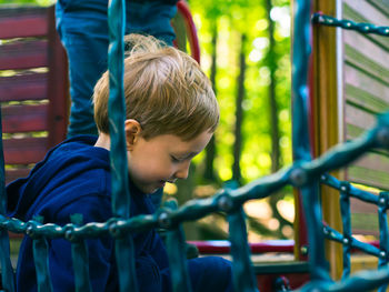 Rear view of boy looking at playground