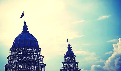 Low angle view of statue of temple against cloudy sky