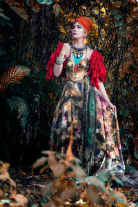 Portrait of young woman with trees in the background