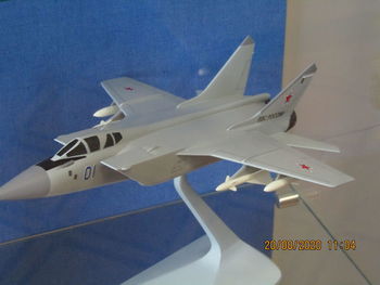 Close-up of airplane flying against blue sky