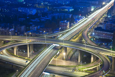 High angle view of light trails on highway at night
