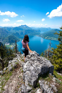 Woman on rock against sky