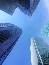 Low angle view of modern buildings against clear blue sky