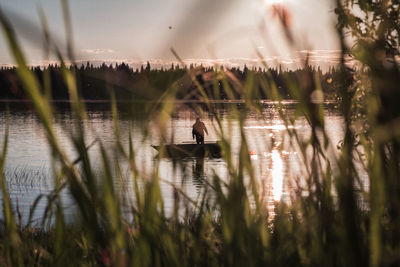 Reflection of man in lake