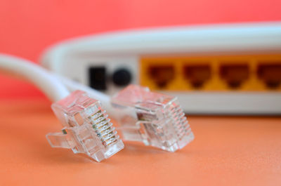 Close-up of router with cables on orange background