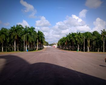 Road amidst trees against sky