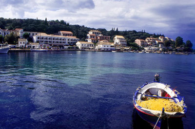 Boats sailing in sea against sky