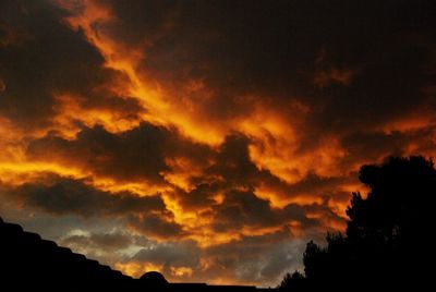 Low angle view of dramatic sky during sunset