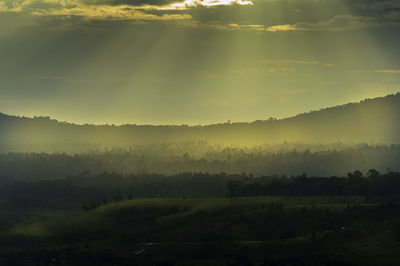 Scenic view of landscape against sky during foggy weather