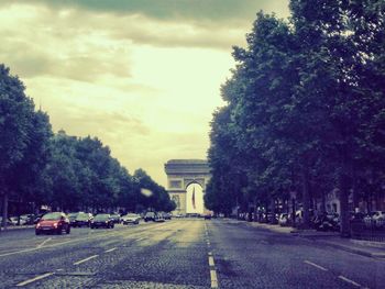 Empty road along trees