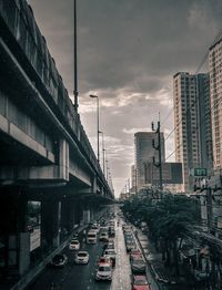 Traffic on city street and buildings against sky