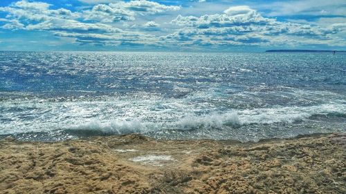 Scenic view of sea against cloudy sky