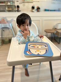 Portrait of boy playing with toy on table