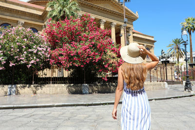 Rear view of woman standing in city