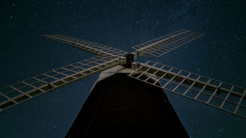 Low angle view of windmill against sky at night