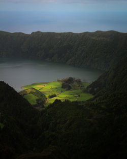 Scenic view of river amidst mountains against sky