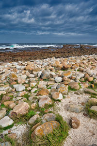 Rocks on beach against sky