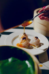 Cropped hand of woman having food