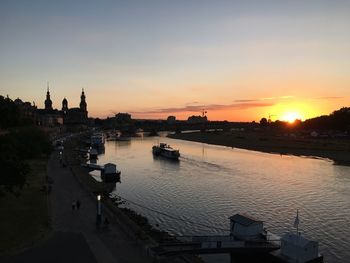 High angle view of river against buildings during sunset