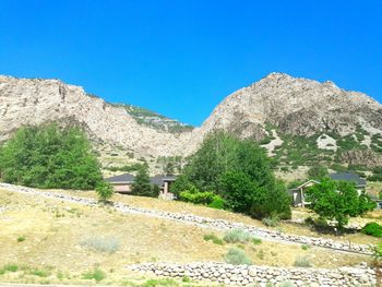 Scenic view of mountains against clear blue sky