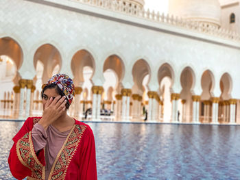 Portrait of woman against a mosque