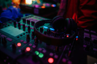 Close-up of sound mixer and headphones at night