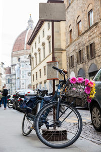 Bicycle decorated with flowers parked at via de cerretani in florence