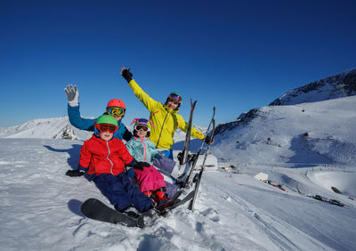 People skiing on snow covered landscape