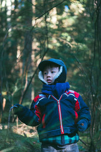 Cute boy standing in forest