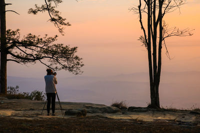 Rear view of man looking at sunset