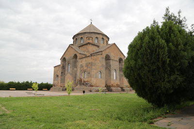 Church by trees against sky