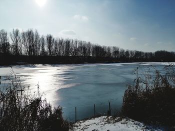 Scenic view of frozen lake against sky during winter