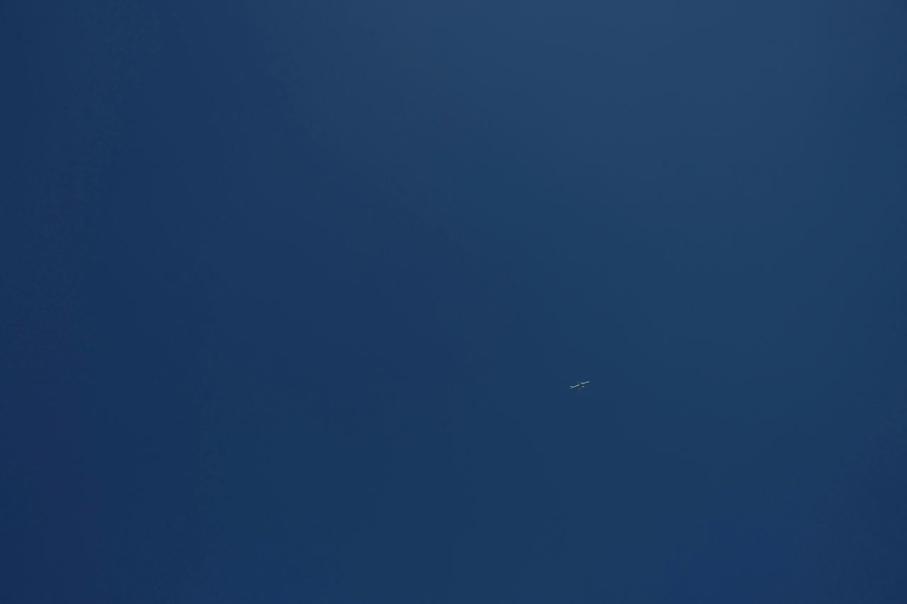 LOW ANGLE VIEW OF MOON AGAINST BLUE SKY