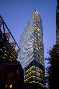 Low angle view of modern buildings against clear blue sky