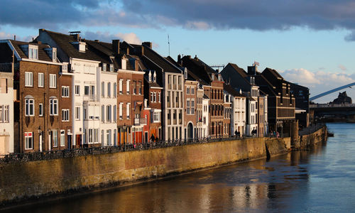 River by buildings in city