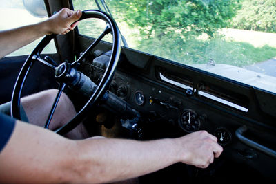 Cropped image of man driving car