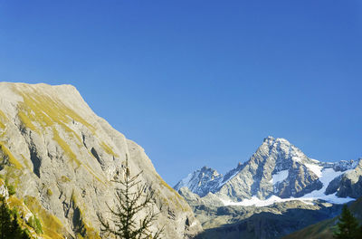 Scenic view of mountains against clear blue sky