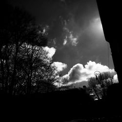 Low angle view of silhouette trees against sky
