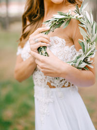 Midsection of bride standing outdoors