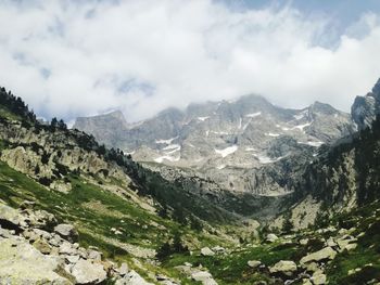 Scenic view of mountains against cloudy sky