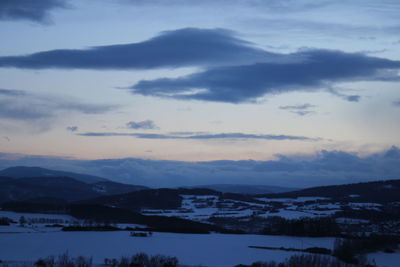 Scenic view of mountains against sky during winter