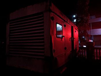 Red illuminated building at night