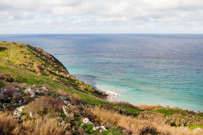 Seacoast on small island gozo, malta. natural seascape with beautiful green coast.