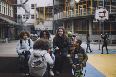 Multiracial friends talking in school campus