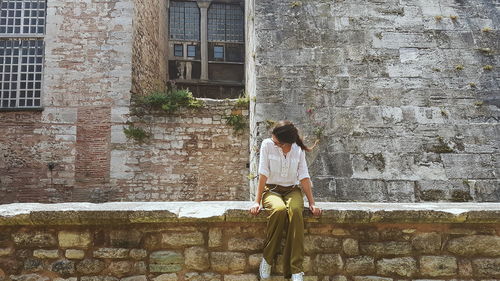 Woman standing on retaining wall