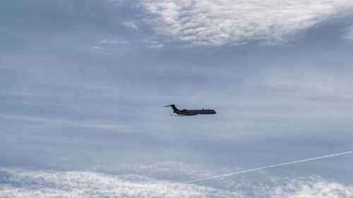 Low angle view of airplane flying in sky