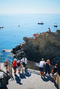 People on beach against clear sky