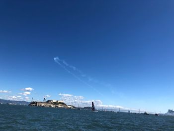 Scenic view of sea against blue sky
