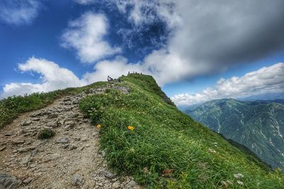 Scenic view of green mountains against sky